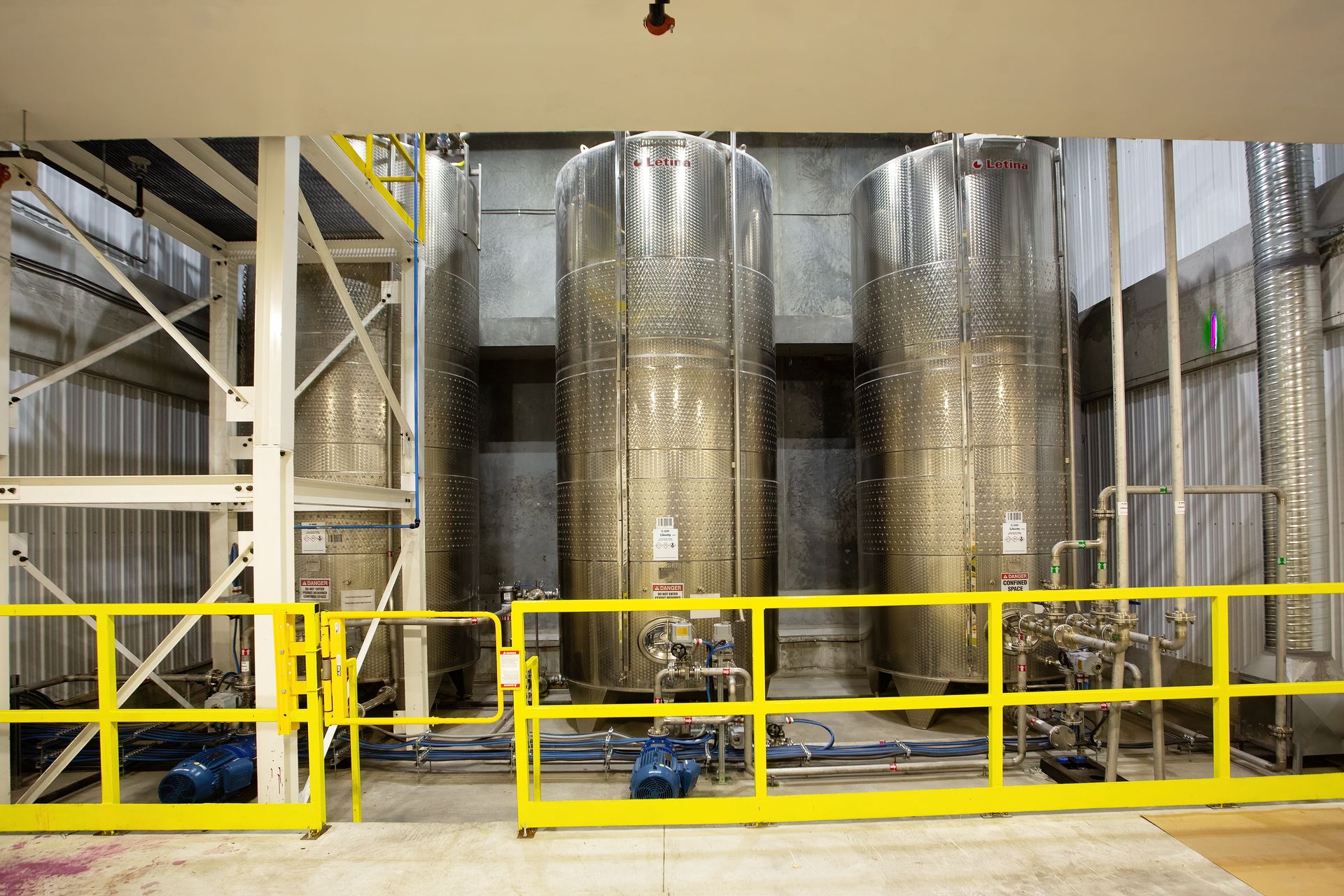 Bank of stainless steel mixing vessels used for chemical formulation