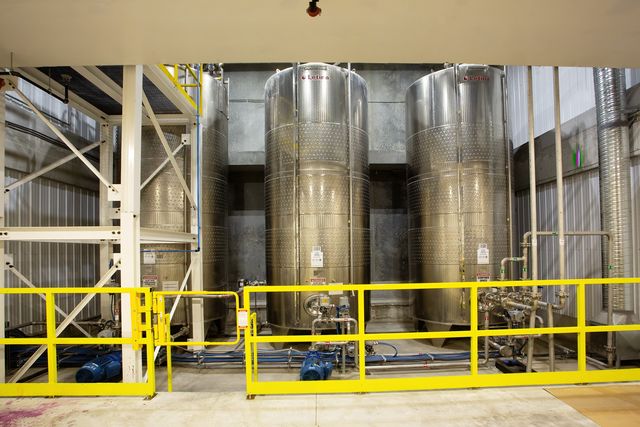 Bank of stainless steel mixing vessels used for chemical formulation